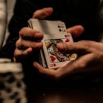 Person holding a deck of playing cards.